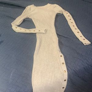 Hera Collection sweater midi dress with function gold snaps down the legs.